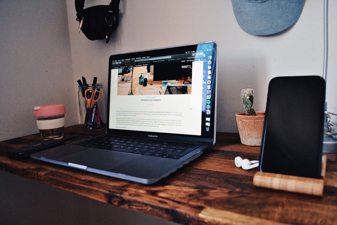 black-laptop-computer-on-brown-wooden-table-kdcojb-tuvc